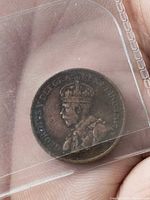 Obverse side showing King George V in holder