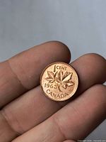 Reverse of 1963 Canadian one-cent coin showing maple leaves and date