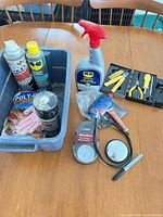 Group shot of sprays, tools, gauges and gloves on table