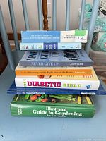 Stack of seven assorted books showing spines