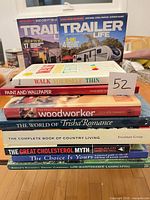 Stacked view of all eight books and two magazines with titles visible