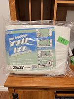 Packaged Smart woven polyethylene tarpaulin showing size 20×28 ft