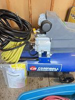 Compressor with attached motor and black/yellow hoses plus manual packet