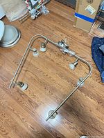 Full view of bendable brushed nickel ceiling track light with five heads