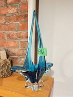 Full view of blue Chalet Canada art glass basket on shelf