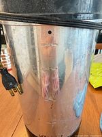 Side view showing metal body, 36-cup level mark and power cord