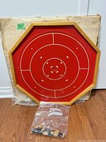 Front view of octagonal crokinole board with discs bagged