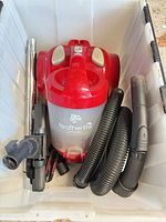 Vacuum body inside bin with hose and floor head visible