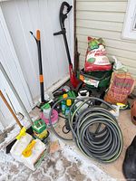 Overall lot showing tools, hose, fertilizer bags, sprayers