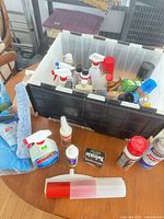 Overview of bin with assorted cleaners and accessories