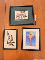 Front view showing all three framed prints with scale reference