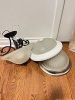 All three ceiling light fixtures grouped together on floor