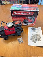 Full lot showing compressor, box, manual and adapters