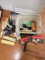Entire lot showing brushes, rollers, edging kits, tools and bin on floor