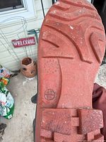 Close-up of boot sole showing tread pattern, size marking 45/10