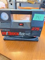 Front view showing full compressor, gauge, handle and graphics