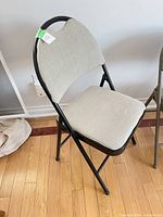 Front angled view of the folding chair showing upholstery and frame