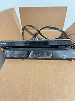 Front view showing Sony DVD player stacked on Bell receiver