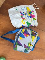 Inflatable vinyl bag and insulated cooler bag on tabletop