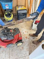 Detached cutting blade held beside mower