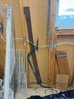 Full view of long crosscut blade, bow saw frame and surrounding context