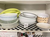 All stacks of plates and bowls on shelf
