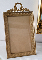Front view of entire brass easel frame