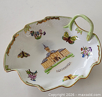 Oblique view of Herend leaf dish showing handle, butterflies, flowers, Szeged building