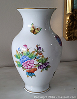 Front view of Herend Queen Victoria vase showing floral and butterfly motif and gold rim