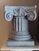 Front view showing volutes, fluted shaft and overall form