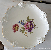 Top view showing full bowl, scalloped rim, floral center