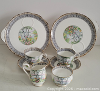 Full set showing two sandwich plates, two teacups on saucers, creamer and sugar bowl