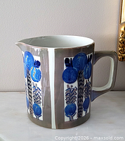 Full view left profile showing pattern, handle and spout