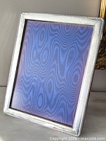 Front view of sterling silver frame showing border and glass
