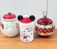 Front view of three ceramic Christmas jars with lids in place