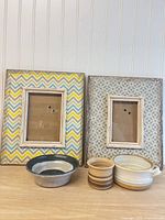 All items together: two patterned frames, three pottery pieces