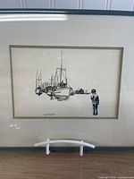 Full view of framed Raymond Chow artwork on stand