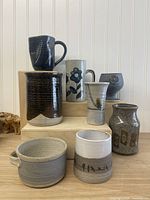 Group shot of all eight stoneware items on display blocks