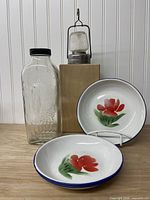 glass bottle, lantern, three enamel plates grouped