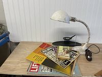 Lamp, pen holder, magazines, paperbacks overview