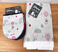 Packaged mini mitts and kitchen towels side by side