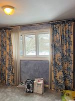 Full window view showing floral and sheer panels hung on rods