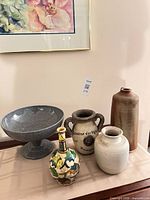 Group shot of all five decorative vessels on table