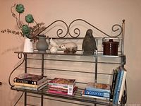 Shelf with cookbooks, crock, figurines, vases and jug