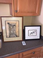 Overall view of both framed prints showing subjects and frames
