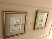Both framed botanical prints hung on wall