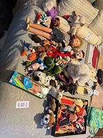 Overview of Chatty Cathy doll, Ken doll box, numerous plush animals, doll clothes