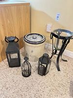 Group shot of stoneware crock and four lanterns