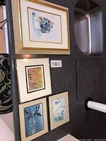 Group shot of four framed artworks on countertop