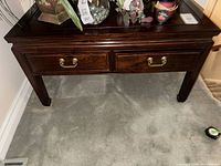 Front view of dark wood console table with two drawers
